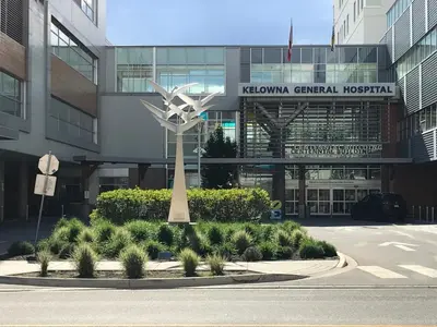 a building with a statue in the middle of a street at Stirling House in Kelowna