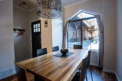 a dining room with a wooden table and a window at Renovated Chalet at Mystic Springs, Mountain Views, Pets Welcome! in Canmore