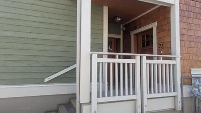 a front porch of a house with a white railing at Settlers Crossing #61 by Bear Country in Sun Peaks