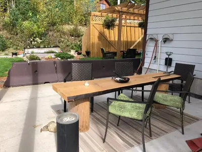a wooden table and chairs on a patio at Peaks Lodge in Revelstoke