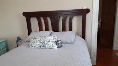 a bed with a stuffed animal sitting on top of it at Sea Birds Cottage in Victoria
