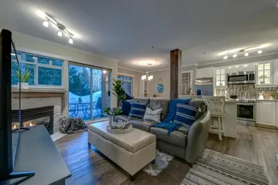 a living room with a couch and a fireplace at Sunpath Retreat- Convenience Meets Comfort & Style in Whistler