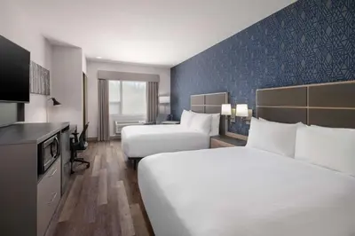 a hotel room with two beds and a television at Best Western Plus Prince George in Prince George