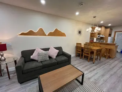 a living room with a couch and a table at Banff Woods lodge in Canmore
