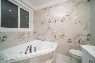 a white bathroom with a sink and a toilet at Sun suite in Surrey