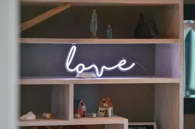 a shelf with a sign that says love on it at Harbourview Executive Condo by EMR Vacation Rentals in Victoria