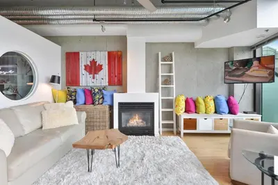 a living room with a couch and a fireplace at Harbourview Executive Condo by EMR Vacation Rentals in Victoria