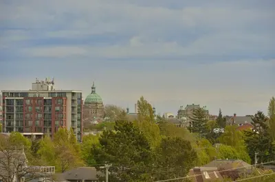 a view of a city with buildings and trees at Harbourview Executive Condo by EMR Vacation Rentals in Victoria