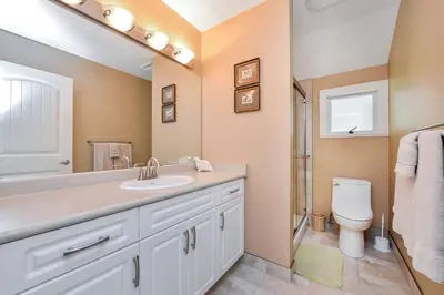 a bathroom with a sink and a toilet at Kye Bay Beach House by EMR Vacation Rentals in Comox