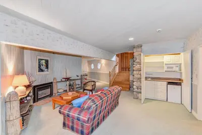 a living room with a couch and a fireplace at Oceanside Lodge Saanich Inlet by EMR Vacation Rentals in North Saanich