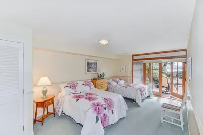 a bedroom with two beds and a window at Oceanside Lodge Saanich Inlet by EMR Vacation Rentals in North Saanich