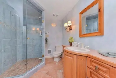 a bathroom with a shower and a toilet and a sink at Oceanside Lodge Saanich Inlet by EMR Vacation Rentals in North Saanich