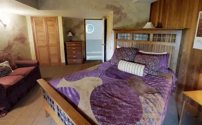 a bedroom with a large bed and a couch at Oceanside Lodge Saanich Inlet by EMR Vacation Rentals in North Saanich