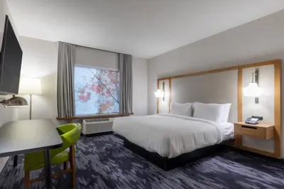 a hotel room with a large bed and a desk at Fairfield Inn & Suites by Marriott Salmon Arm in Salmon Arm