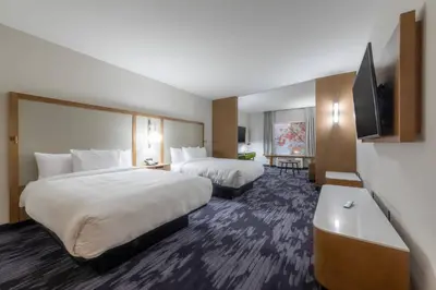 a hotel room with two beds and a flat screen tv at Fairfield Inn & Suites by Marriott Salmon Arm in Salmon Arm