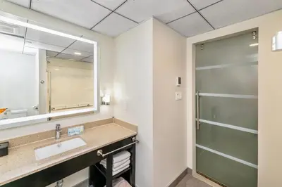 a bathroom with a sink and a shower at Quality Inn Sunshine Suites in Terrace