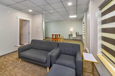 a waiting room with a couch and a table at Quality Inn Sunshine Suites in Terrace