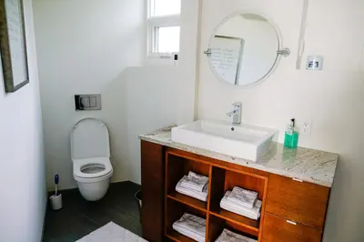 a bathroom with a sink and a toilet at Studio on Capri in Calgary