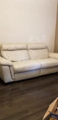 a white couch sitting in a living room at Parson Creek Cozy suite in Fort McMurray