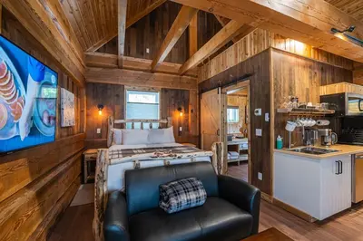 a bedroom with a bed and a couch in a room at Boulder Mountain Resort in Revelstoke