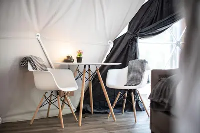 a table and two chairs in a tent at Boulder Mountain Resort in Revelstoke