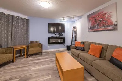 a living room with a couch and a tv at Luxurious One Bedroom Suite for a Larger Family 162 in Canmore
