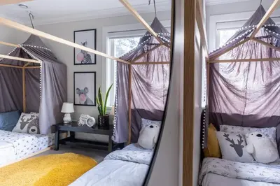 a bedroom with two beds and a mirror at 5-Star Luxury and comfortable home in New Westminster