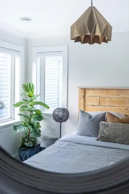 a bedroom with a bed and a plant and windows at 5-Star Luxury and comfortable home in New Westminster