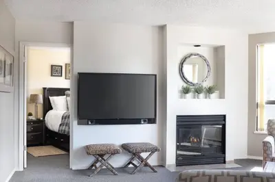 a living room with a tv and a fireplace at Mountain View Penthouse- 2BR Oasis at the Marquise in Whistler in Whistler