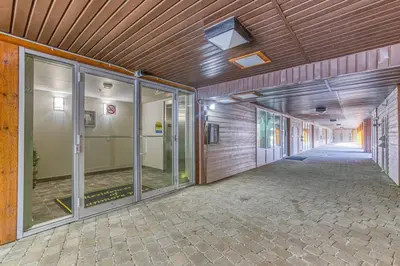 an empty hallway with glass doors in a building at Rundle Rise - Spacious Condo Steps from Main Street in Canmore