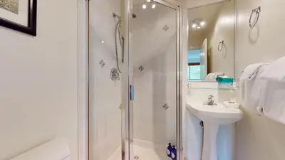 a bathroom with a shower and a sink at 2BR in Symphony, Whistler Village, Complex Hot Tub, Gas Fireplace, Parking, Gondola Shuttle in Whistler