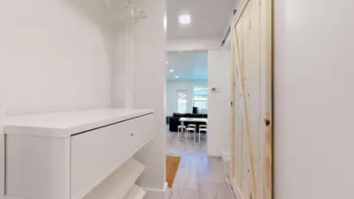 a kitchen with white cabinets and a dining room at 1BR and Sofabed at Whistler on the Lake, Lakefront, Serene Setting, Wood Burning Fireplace in Whistler