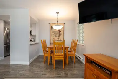 a kitchen and dining room with a table and chairs at 1BR in Northstar, Village Location, Gas Fireplace, Shared Hot Tub, Ski Storage in Whistler