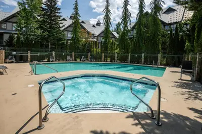 a large swimming pool in a yard at 1BR in Northstar, Village Location, Gas Fireplace, Shared Hot Tub, Ski Storage in Whistler
