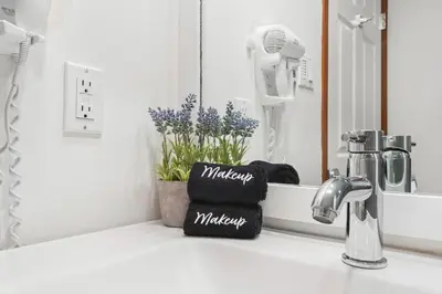 a bathroom counter with a sink with a mirror at 2BR in The Aspens, Ski In, Ski Out, Pool and Hot Tub, Gas Fireplace, Ski Valet, Gym in Whistler