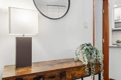 a mirror on a wall above a table with a plant at 2BR in The Aspens, Ski In, Ski Out, Pool and Hot Tub, Gas Fireplace, Ski Valet, Gym in Whistler