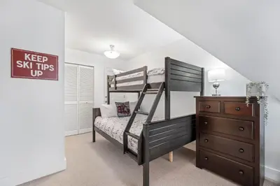 a bedroom with a bunk bed and a dresser at 3BR in Gleneagle, Soaker Tub with Skylight, Wood Burning Fireplace, Spacious Layout in Whistler