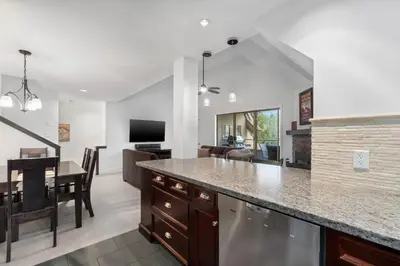 a kitchen and living room with a dining room at 3BR in Gleneagle, Soaker Tub with Skylight, Wood Burning Fireplace, Spacious Layout in Whistler
