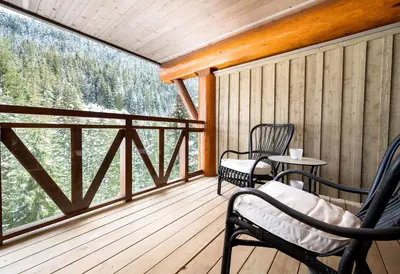 a screened in porch with two chairs and a table at 3BR Luxury Home in Taluswood, Hot Tub, Ski In, Ski Out, Two-Car Garage, Village Parking in Whistler