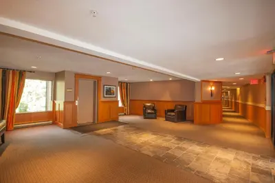 a room with a hallway with a living room at 2BR in Powderhorn, Near Blackcomb, Double-Sided Fireplace, Rooftop Hot Tub, Parking in Whistler