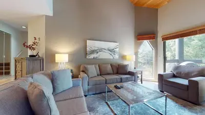 a living room with two couches and a glass table at 2BR in Ironwood, Fireplace, Common Area Hot Tub, Private Patio, Parking in Whistler