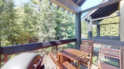 a deck with a table and chairs on a balcony at 2BR in Ironwood, Fireplace, Common Area Hot Tub, Private Patio, Parking in Whistler