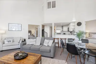 a living room with a couch and a table at 3BR in Tyndall Stone Lodge, Village Location with Olympic Plaza Views, Fireplace, Hot Tub in Whistler