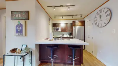a kitchen with a sink and a clock on the wall at 2BR plus Den in The Gables, Unbeatable Location Near Gondolas, Private Balcony, Secure Parking in Whistler