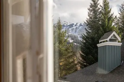 a view from a window of a mountain at 2BR in Granite Court, Village Location, King Bed, Private Balcony, Parking, Fireplace in Whistler