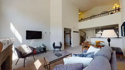 a living room with a couch and a table at 1BR plus Loft in Tyndall Stone Lodge, Village Location, Pool and Hot Tub, Private Balcony in Whistler