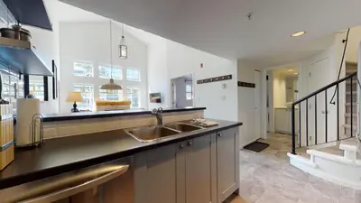 a kitchen with a sink and a counter top at 1BR plus Loft in Tyndall Stone Lodge, Village Location, Pool and Hot Tub, Private Balcony in Whistler