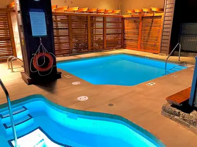 a swimming pool in a building with a pool at 1BR plus Loft in Tyndall Stone Lodge, Village Location, Pool and Hot Tub, Private Balcony in Whistler