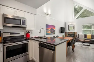 a kitchen with a sink and a stove top oven at 2BR plus Loft in Wildwood Lodge, Free Ski Bus, Hot Tub and Pool, Private Patio, Parking in Whistler