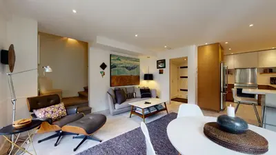 a living room with a couch and a table at 2BR in The Gables, Steps to Gondolas, Heated Floors, Private Balcony, Fireplace in Whistler